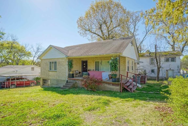 back of property featuring a yard