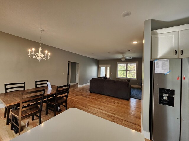 unfurnished room featuring a healthy amount of sunlight, light wood-type flooring, and ceiling fan