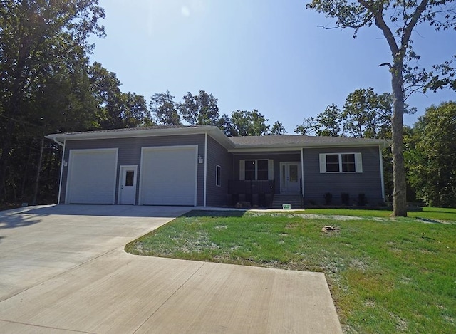 ranch-style house featuring a front yard and a garage