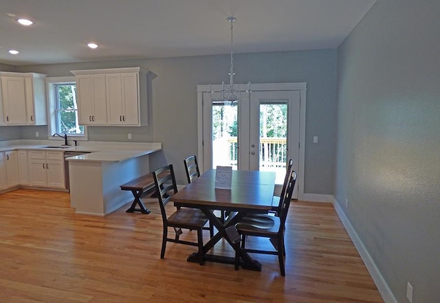 dining space featuring light hardwood / wood-style floors and sink