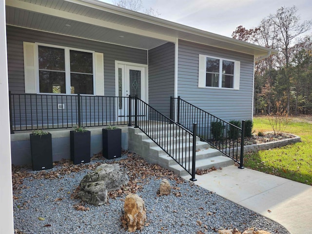 view of exterior entry with covered porch