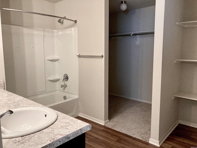 bathroom featuring vanity, bathtub / shower combination, and hardwood / wood-style flooring