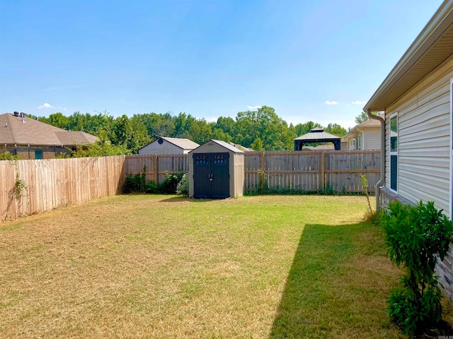 view of yard featuring a gazebo and a storage shed