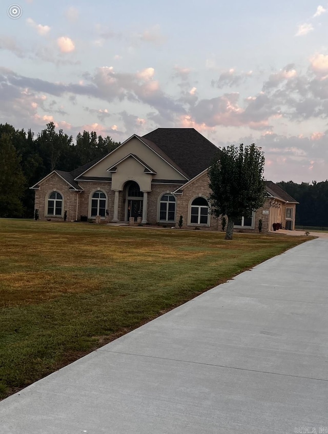 ranch-style home featuring a lawn