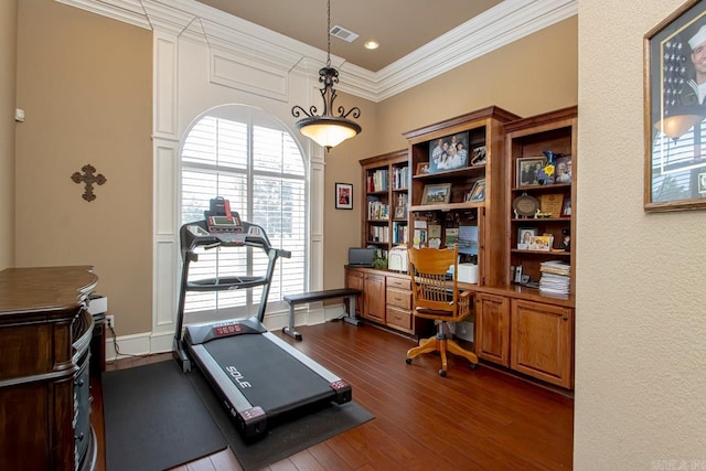 exercise room with dark hardwood / wood-style flooring and ornamental molding