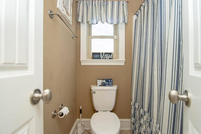 bathroom with walk in shower and toilet