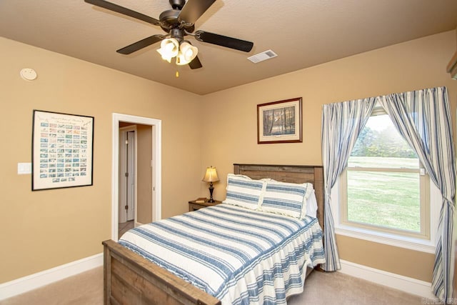 bedroom with multiple windows, ceiling fan, and carpet flooring