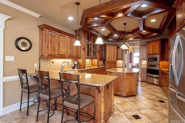 kitchen with a kitchen island, coffered ceiling, pendant lighting, appliances with stainless steel finishes, and kitchen peninsula