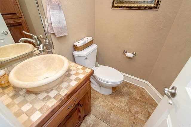 bathroom with tile patterned flooring, toilet, and vanity