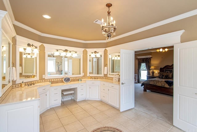 bathroom with tile patterned flooring, plenty of natural light, ornamental molding, and vanity