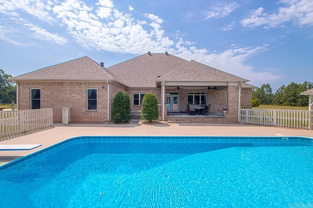 view of swimming pool featuring ceiling fan and a patio