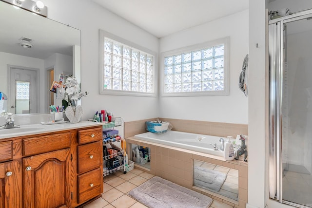 full bath featuring a garden tub, visible vents, vanity, a shower stall, and tile patterned floors