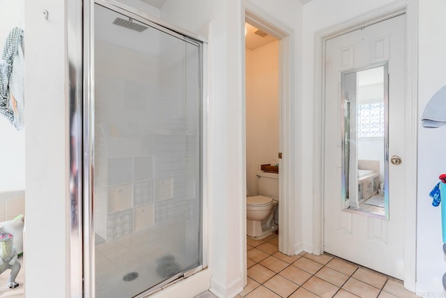 bathroom with visible vents, a stall shower, tile patterned flooring, and toilet