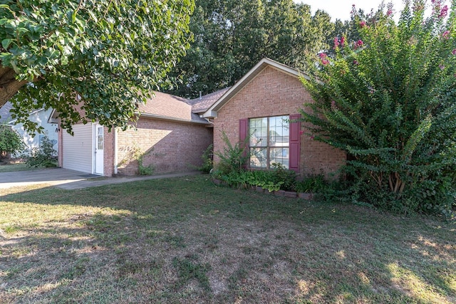 view of front of home with a front yard and brick siding