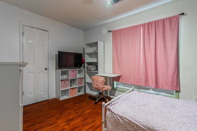 bedroom with dark wood-style floors