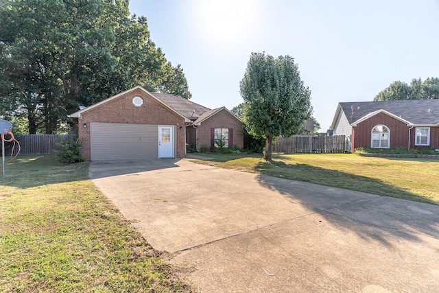 ranch-style house featuring a front yard, concrete driveway, brick siding, and fence