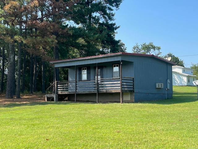 manufactured / mobile home with covered porch and a front lawn