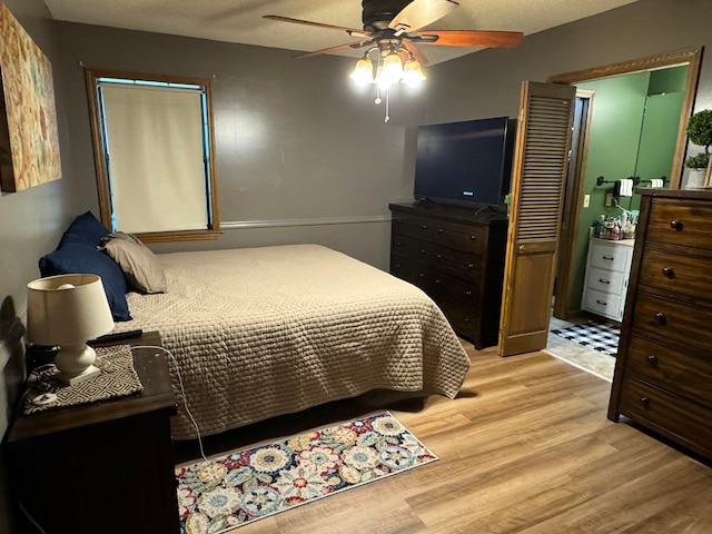 bedroom with ceiling fan and light hardwood / wood-style floors