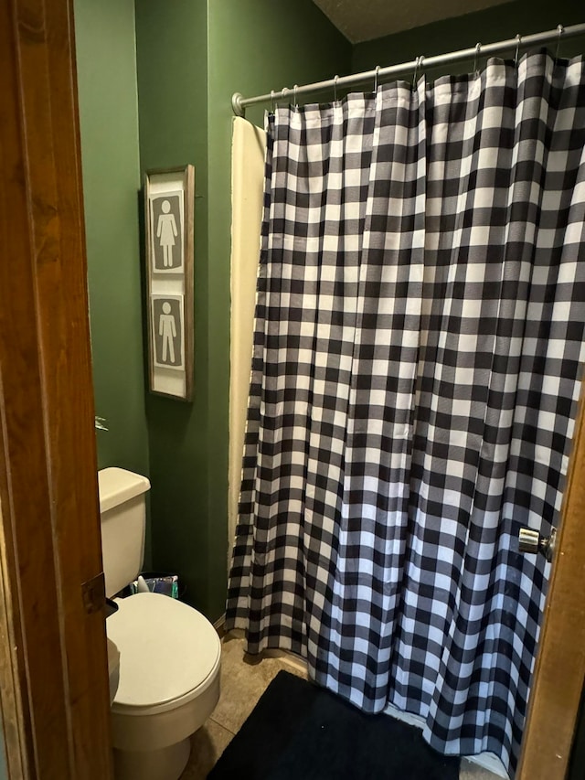 bathroom featuring tile patterned flooring and toilet