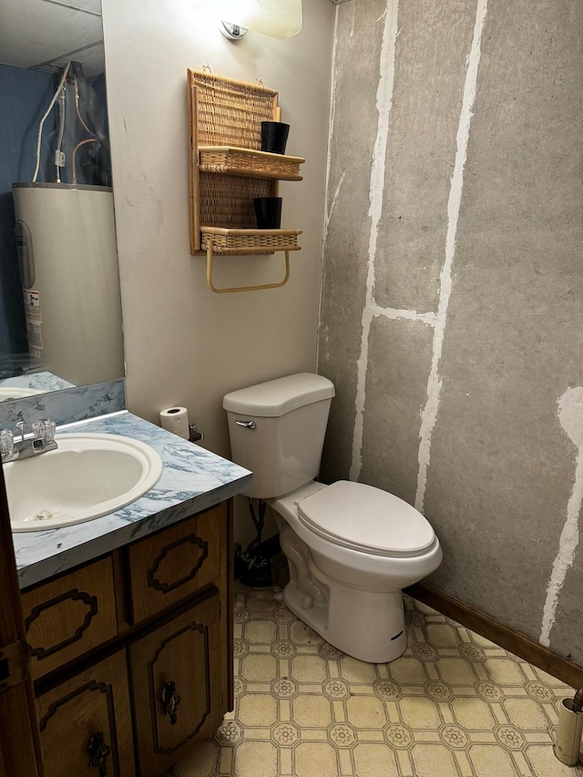 bathroom featuring vanity, toilet, water heater, and tile patterned flooring