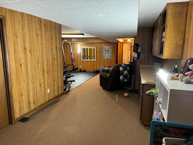 kitchen featuring light colored carpet and wood walls