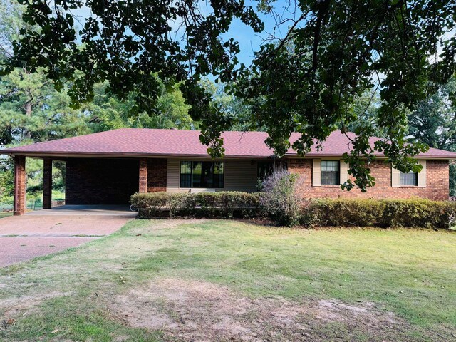 single story home featuring a front yard and a carport