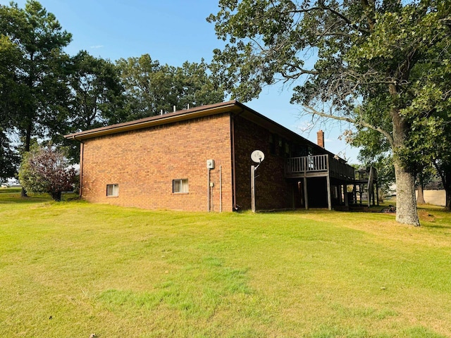 view of home's exterior featuring a lawn and a deck