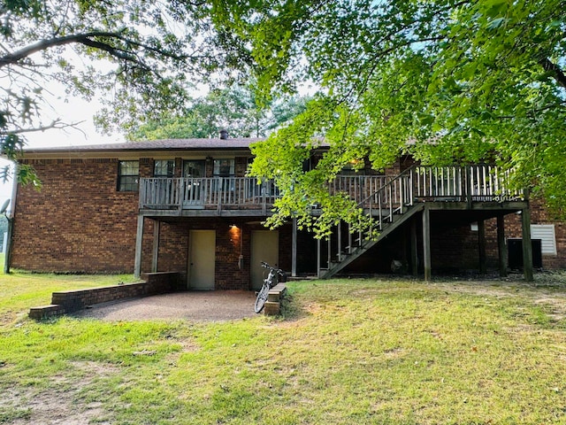 back of property with a lawn, a patio, and a deck