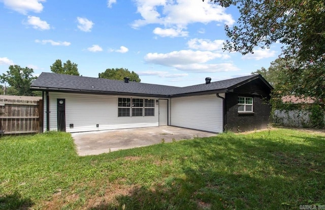 back of house with a lawn and a patio