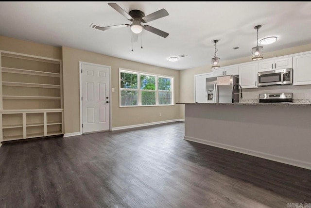 kitchen featuring white cabinets, appliances with stainless steel finishes, and dark hardwood / wood-style floors