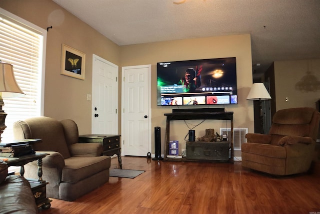 living room featuring wood finished floors and visible vents