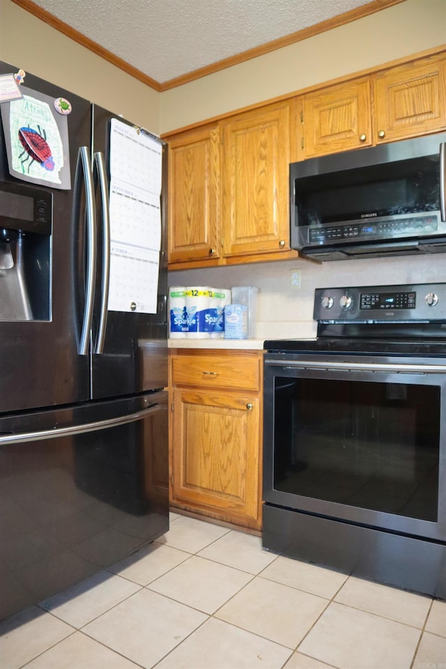 kitchen with brown cabinets, light countertops, appliances with stainless steel finishes, ornamental molding, and a textured ceiling