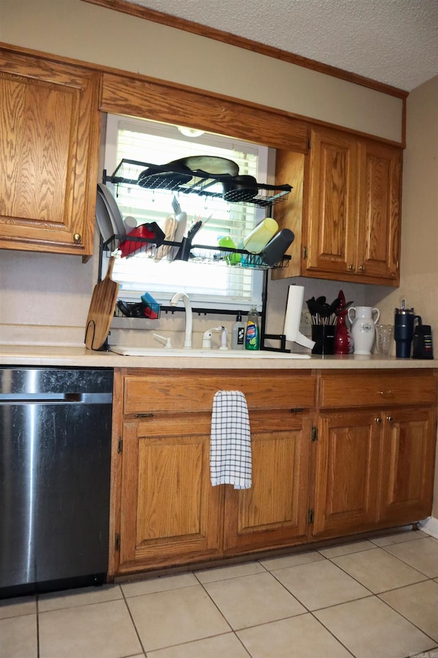 kitchen with a textured ceiling, brown cabinets, dishwasher, and light countertops