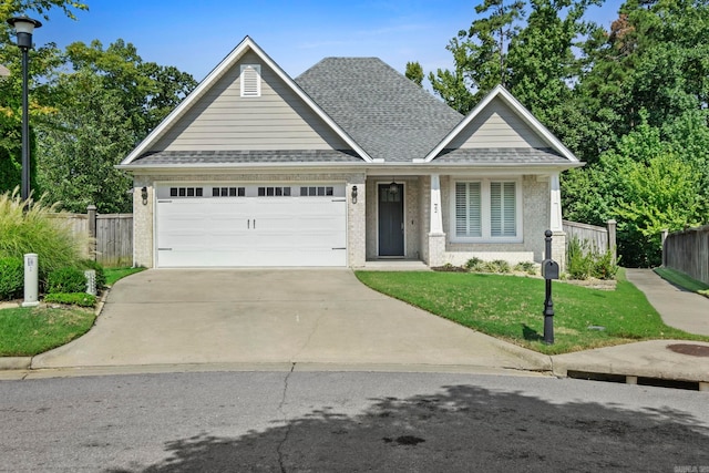 craftsman-style house with a garage and a front lawn