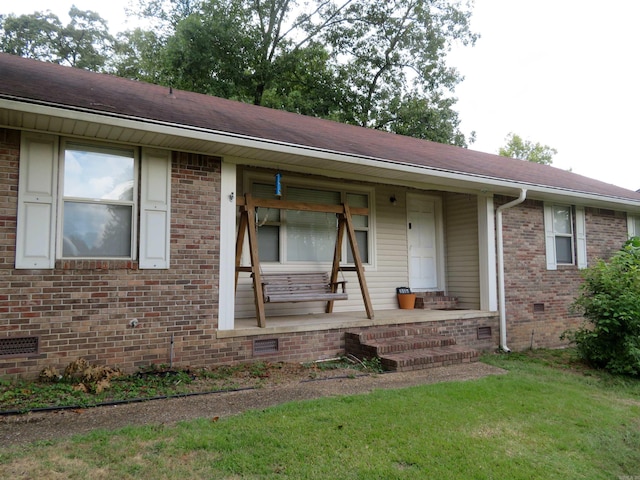 ranch-style home featuring a front yard and a porch