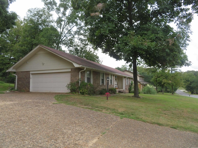 ranch-style home with a front lawn and a garage