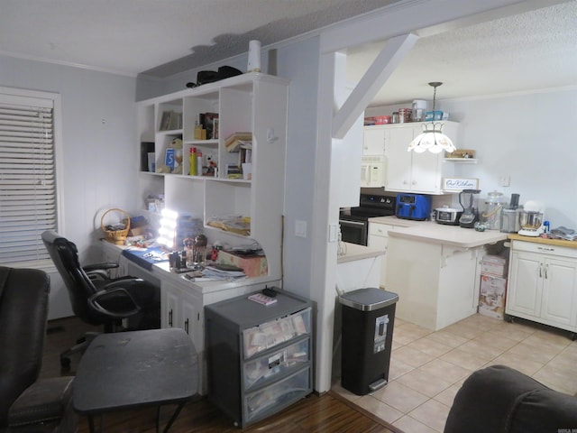 kitchen featuring hanging light fixtures, black electric range oven, ornamental molding, and white cabinets