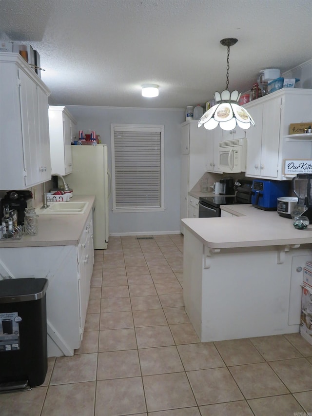 kitchen with white appliances, sink, kitchen peninsula, white cabinetry, and decorative light fixtures