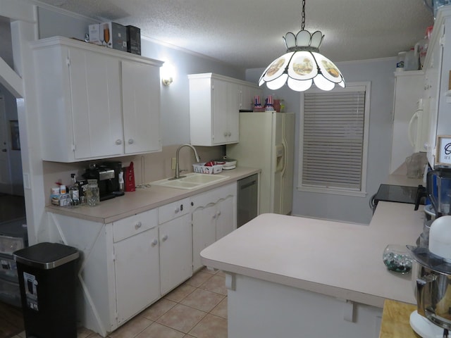 kitchen featuring hanging light fixtures, stainless steel appliances, sink, white cabinetry, and a textured ceiling