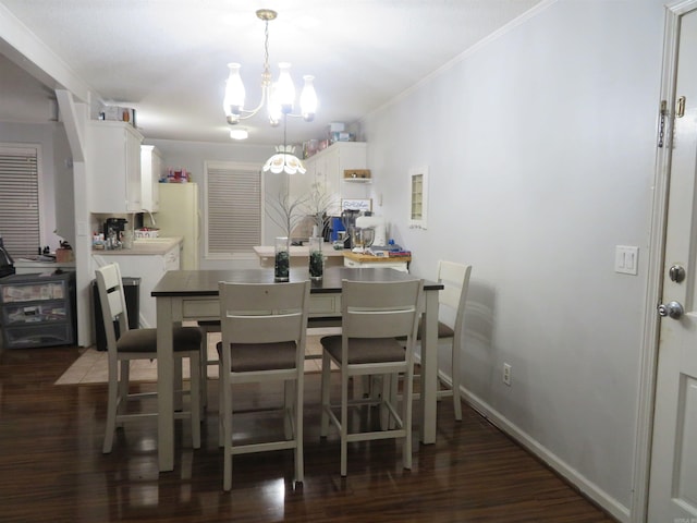 dining room featuring ornamental molding, an inviting chandelier, and dark hardwood / wood-style floors