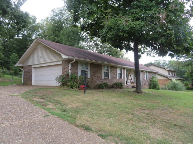 ranch-style home with a front lawn and a garage