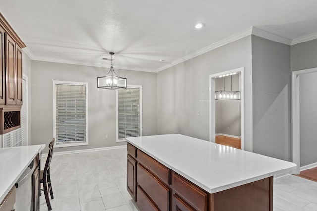 kitchen featuring a chandelier, light countertops, crown molding, and baseboards