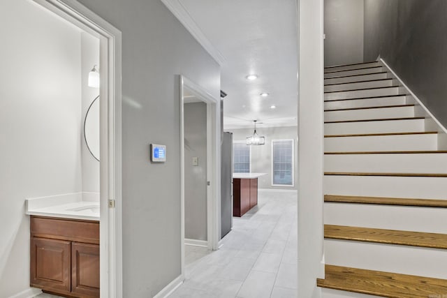 staircase with baseboards, recessed lighting, and crown molding