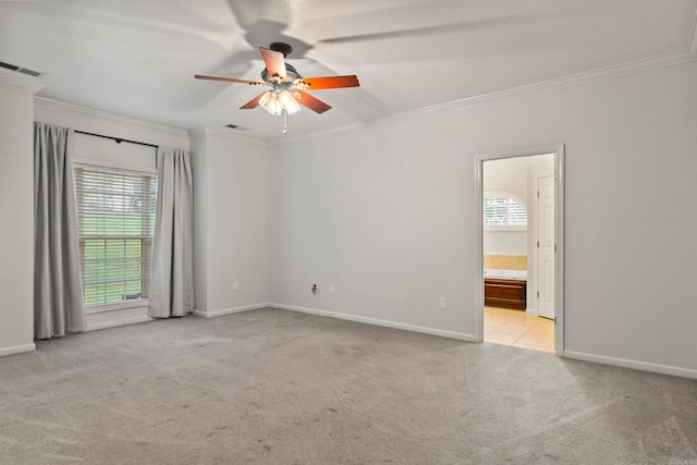 unfurnished room featuring ornamental molding, carpet, visible vents, and a ceiling fan