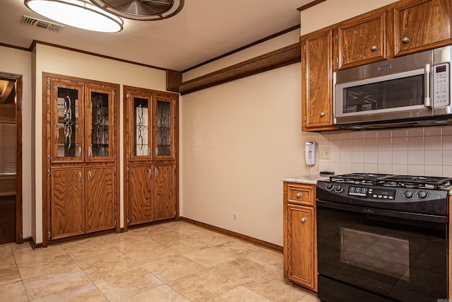 kitchen with backsplash, black gas range, crown molding, and light tile patterned flooring