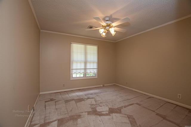 carpeted empty room featuring a textured ceiling, ceiling fan, and ornamental molding