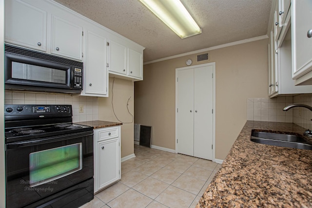 kitchen featuring black appliances, white cabinets, and tasteful backsplash