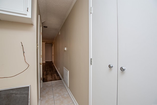 hallway featuring a textured ceiling and light wood-type flooring