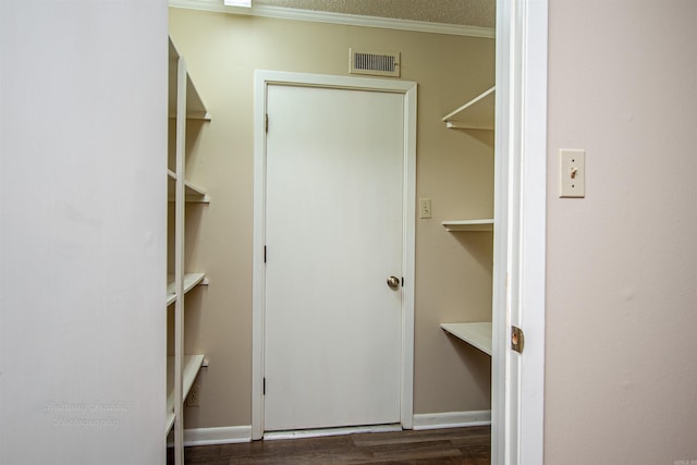 walk in closet with hardwood / wood-style flooring