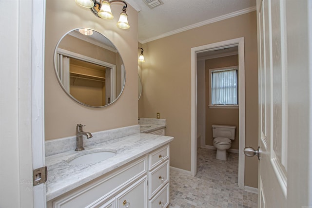 bathroom with toilet, tile patterned flooring, ornamental molding, vanity, and a textured ceiling